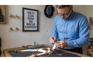 a man trying to clean and repair a suspender