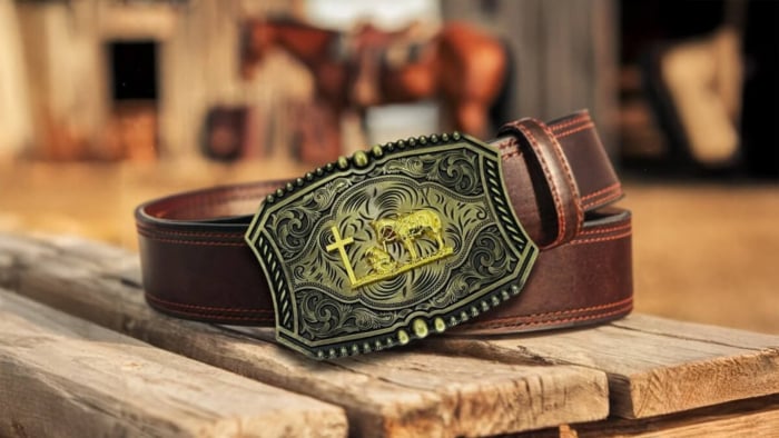 brown belt and vintage belt buckle on a wood stand with western background