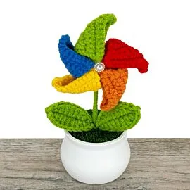 rainbow colored rolling crochet windmill flower in pot