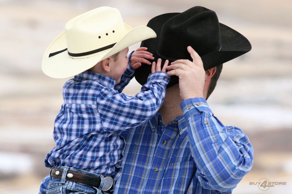 father and son wearing cowboy hat and playing together