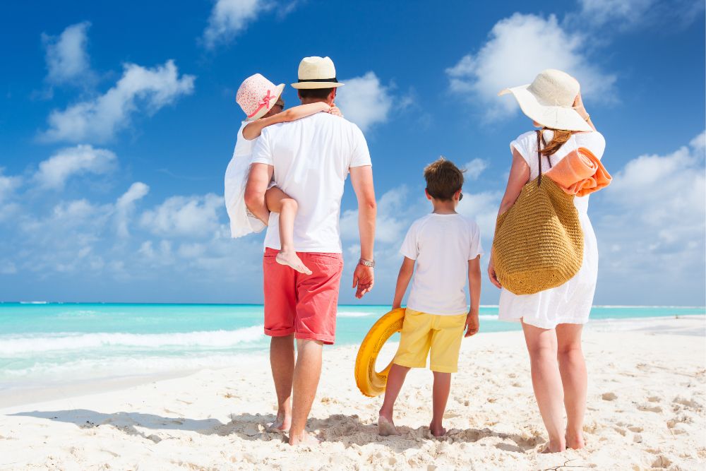 a family wearing summer hats on the beach