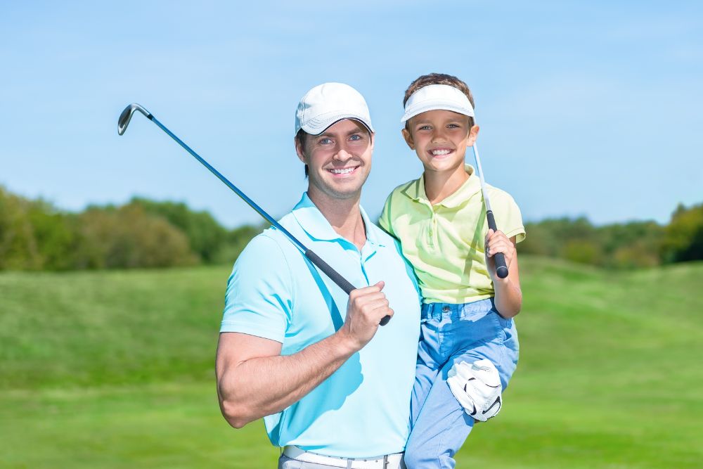 dad and his kid wearing golf hats and enjoying time