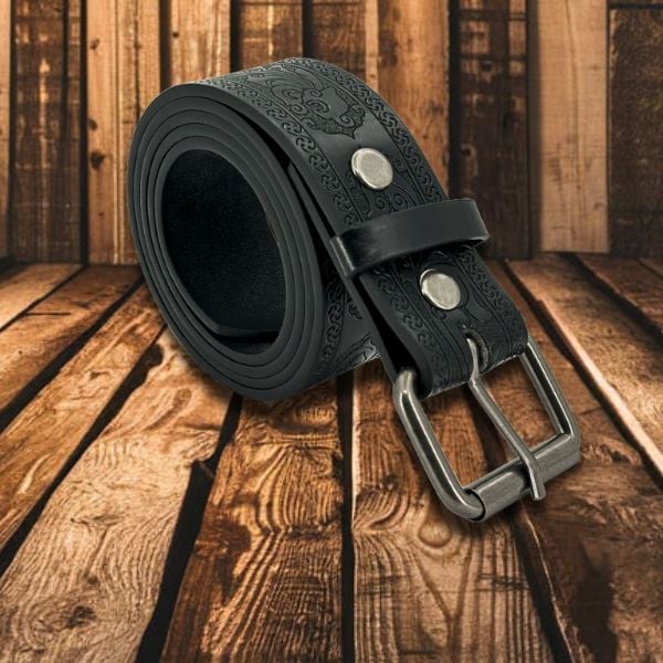 black engraved western belt on wood