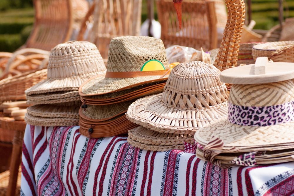 selling straw summer hats on the event